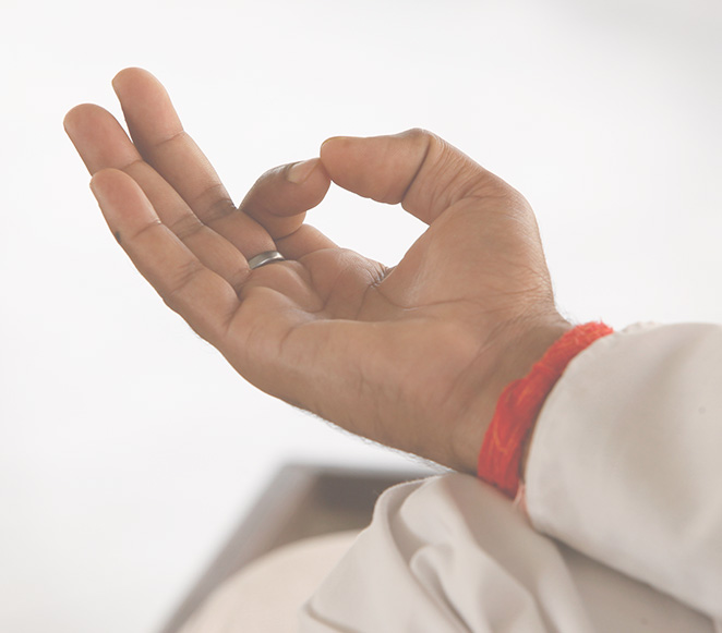 A person making a meditation sign during a Yoga pose